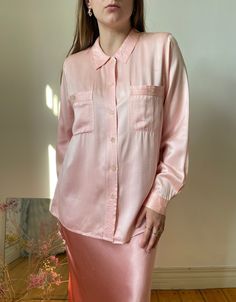 Beautiful Italian vintage pink blouse made out of gorgeous charmeuse silk blouse with a satin shine to it. Truly pretty.  tag size: 40, best fits xs - s, might fit m, however, please see measurements  circa: 90s  overall in great condition, no major flaws, has a very light mark at the front  MEASUREMENTS *taken seam to seam. not doubled, taken flat Shoulders: 38 cm | 14.9" Bust: 49 cm | 19.2" Sleeve length: 57.5 cm | 22.6" Length: 62 cm | 24.4" For reference, our model is size S and is 5"2 tall Pink Satin Feminine Blouse, Pink Satin Blouse In Feminine Style, Pink Silk Button-up Blouse, Pink Silk Button-up Top, Long Sleeve Pink Satin Top, Pink Long Sleeve Satin Top, Pink Satin Long Sleeve Tops, Pink Satin Top For Work, Silk Pink Top For Workwear