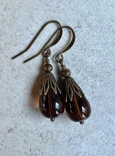 "brown earrings   czech glass teardrop earrings   boho dangle earrings These are large, transparent brown, Czech glass rounded teardrop beads. Each one wears an antiqued brass filigree cap and small round bead. Hook ear wires are antiqued brass. Length of earrings from top of ear wires is 1 5/8\". Teardrops measure 11x17mm. You can enter my shop here: gypsydanges.etsy.com"