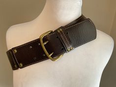 "Vintage Banana Republic wide dark brown leather belt featuring 3 sections with antiqued brass double studs linking the panels.  Antique brass buckle with double prongs and the brass studded leather retainer ..Stitching details accent each panel and retainer... chic streetwear style - jeans, accent a suit or a casual dress. Great Vintage condition ...Original attached tag $79.00 Material: Dark Brown Leather....antiqued brass hardware. Brand Label: Banana Republic Measurements: Buckle 2 7/8\"  x