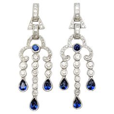 Discover the epitome of elegance with these captivating chandelier dangle earrings, exquisitely crafted in 14 karat white gold. A testament to timeless beauty, these earrings boast a delightful combination of natural sapphires and diamonds, sure to leave a lasting impression. The natural sapphires take center stage, with a total carat weight of 1.12. The sapphires feature a mix of pear and round cuts, expertly faceted to enhance their deep blue hue. The vibrant color of the sapphires adds a touch of sophistication and allure to these earrings, making them a standout piece in any collection. Complementing the sapphires are sparkling natural diamonds, totaling 0.95 carats. The diamonds showcase a brilliant mix of round and princess cuts, allowing them to catch the light from every angle. Wit Diamond Chandelier, Earrings Making, Sapphire Color, Gold Chandelier, Princess Diamond, Natural Sapphire, Center Stage, Belle Epoque, Sapphire Diamond