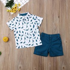 Get your little one ready for summer in style with this adorable set! Featuring a button down shirt with a playful dinosaur pattern and matching shorts, this set is perfect for any toddler boy. The turn-down collar and short sleeves add a touch of casual cool to this must-have summer outfit. (Roar-some!) Cotton Dinosaur Print Sets With Short Sleeves, Cotton Sets With Dinosaur Print And Short Sleeves, Summer Dinosaur Print Playtime Sets, White Dinosaur Print Summer Sets, White Summer Sets With Dinosaur Print, Cute Dinosaur Print Sets For Summer, Romper And Jacket, Dinosaur Pattern, Matching Shorts