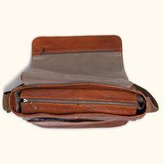 Crafted from the rich and textured full grains of buffalo hide, our limited edition Roosevelt Buffalo Leather Satchel showcases the deep and natural brown grains unique to each piece. With dimensions of 17" long and 13" high, it offers padded space for a 15" laptop screen display laptop (measured diagonally), additional storage under the flap, and an area to hold pens and accessories. Safeguard your valuables in the interior or exterior zipper pockets. The satchel's interior features our interio Cognac Pebbled Leather Shoulder Bag With Leather Lining, Brown Leather Lined Saddle Bag For Travel, Brown Saddle Bag With Leather Lining For Travel, Brown Leather-lined Saddle Bag For Travel, Brown Leather Shoulder Bag With Smooth Grain, Textured Leather Saddle Shoulder Bag For Travel, Cognac Pebbled Leather Shoulder Bag For Everyday, Everyday Cognac Pebbled Leather Shoulder Bag, Classic Textured Leather Saddle Bag For Daily Use