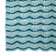 a crocheted blanket with waves on it