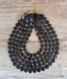 A lightweight multi strand beaded statement necklace made with black wood beads and black glass spacers. - 5 strands (more strands are listed)- Beads measure .5" across - Shortest strand measures 18.5-20.5" (length varies depending on the clasp)- Lobster claw clasp is gold filled (stainless steel, gold stainless and sterling silver are also available) - Connector is gold lead free pewter- 2" inch gold stainless steel extender chainThe length can be customized. We use the highest quality findings Silver Jewelry Box, Chunky Statement Necklace, Wood Bead Necklace, Wood Necklace, Beaded Statement Necklace, Chunky Necklace, Black Wood, Multi Strand, Black Glass