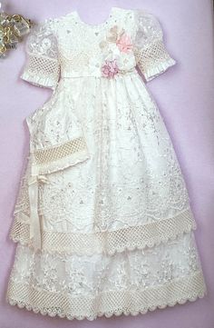 This Christening dress by will make any baby's blessing a very special event. Stunning 3 Pcs long gown with shantung material: sleeveless inner gown with simple trim on the bodice and full lace skirt and 3/4 lace sleeve outer gown with stunning floral lace and removable flower brooch on the waist. On the back it features oversized waist bow tie and button closure. Comes in ivory. Matching elastic headband included. First Communion Lace Dress For Pageant, First Communion Lace Dress With Lace Trim For Pageant, Lace First Communion Dress For Pageant, Lace First Communion Dress With Lace Trim For Pageant, Cream Lace Baptism Dress For Pageant, Cream Lace Gown For First Communion, Cream Lace Pageant Gown, Cream Lace Gown For Pageant, Lace Baptism Dress With Lace Bodice For Pageants