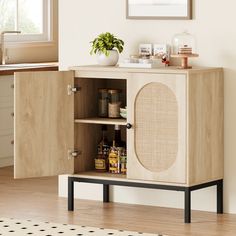 a wooden cabinet with an open door and shelves on the side, next to a potted plant