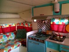 a kitchen with a stove top oven next to a couch