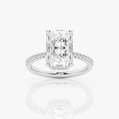 an engagement ring with a cushion cut diamond in the center and pave set shoulders