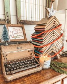 an old fashioned typewriter sitting on top of a table next to a christmas tree