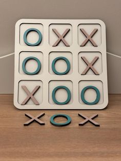 an xoxo game is displayed on a table next to the letters xo and o