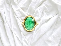 Unveil the Power Within: Embrace the captivating allure of the emerald with this captivating unisex pinky ring. Handcrafted by skilled artisans from solid 18k gold, this enigmatic piece features a mesmerizing 5-carat oval cut emerald gemstone.  Its vibrant green hue symbolizes growth, prosperity, and inner strength, making it a powerful statement for anyone who dares to be bold. A Gemstone for All: The emerald transcends gender limitations.  Long associated with royalty, leadership, and achieving greatness, this ring empowers anyone who wears it.  Whether you identify as a man or a woman, this ring allows you to embrace your inner strength and potential. A Statement Piece Like No Other: The impressive 5-carat emerald takes center stage, commanding attention and sparking conversation.  This Handmade Luxury Emerald Ring For Formal Occasions, Luxury Handmade Emerald Ring For Formal Occasions, Unique Yellow Gold Oval Emerald Ring, Unique Oval Emerald Ring In Yellow Gold, Gold Emerald Ring With Large Oval Stone, Unique Oval Cabochon Emerald Ring, Unique Oval Emerald Ring With Polished Finish, Oval Cabochon Emerald Ring Gift, Handmade Oval Emerald Ring