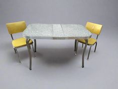 a table with four chairs around it and a white tile top on the bottom, in front of a gray background