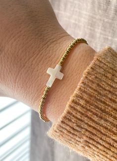 Mini Cross Bracelet  🤍✝️ Dainty bracelet to add to your stack or wear by itself.  Made with small natural shell cross and 3mm 18k Gold filled beads for no tarnish ✨✨ CARING TIPS FOR YOUR JEWELRY ⭐️Treat and store with care. ⭐️ For longevity, avoid exposing your jewelry to water. ⭐️ Avoid having direct contact with lotions, perfumes, sanitizers as these chemicals may cause discoloration of your jewelry. Gold Cross Bracelet, Shell Cross, Preppy Jewelry, Small Bracelets, Faith Gifts, Catholic Jewelry, Mini Cross, White Cross, Bracelets Diy