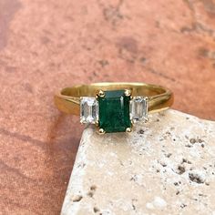 Vintage/ antique 18KT yellow gold emerald-cut Colombian emerald + diamond accent ring. Absolutely stunning and high quality ring which would be fantastic as an engagement, birthstone, or celebration piece. Size 9 Can be resized for an additional fee 1.25 CT plus natural, Colombian emerald Emerald measures: 7mm x 5.3mm Inclusions in stone, but deep color and saturation 2 natural, emerald-cut, natural diamonds VS clarity; H color diamonds .50 CTW diamonds Weight: 4.65 grams Estate condition. 1 Sid Emerald Cut Three Stone Emerald Ring, Heirloom Emerald Ring Baguette Cut, Heirloom Style Baguette Cut Emerald Ring, Heirloom Baguette Cut Emerald Ring, Classic Emerald Cut Emerald Ring For Proposal, Three-stone Emerald Cut Emerald Ring For May Birthstone, Three Stone Emerald Cut Emerald Ring, Heirloom Emerald Cut Green Wedding Ring, Gift Emerald Ring With Three Stones In Radiant Cut