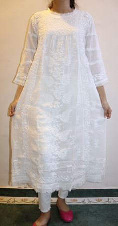 Personifying Grace and Elegance, our Muslin Victoria Dress with ruffle inserts on the neck,sleeves and hem is intricately embroidered in chikankari by our skilled artisans. Muslin adds flavour and comfort to this dress with its softness and fluidity. Inclusive with matching inner (lining) This Dress is dyeable. Length stands at 47/48 inches Available in sizes : XS - bust 34 S - bust 36 M - bust 38 L - bust 40 XL - bust 42 0X - bust 44 Elegant Cotton Dress With Cutwork Details, Traditional Lace Dress With Chikankari Embroidery, Cotton Wedding Dress With Cutwork, Wedding Cotton Dress With Cutwork Details, Wedding Cotton Dress With Cutwork, Embroidered Chikankari Straight Kurta Dress, Festive Cotton Dress With Lace Work, Traditional Cotton Dress With Cutwork, Traditional Cotton Cutwork Dresses