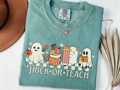 Featuring a playful design of cute ghosts, this sweatshirt is perfect for teachers who love to embrace the Halloween spirit. Made from soft, comfortable fabric, it's ideal for a fun and festive classroom atmosphere. ⭐Fabric Our adult Comfort Colors® T-shirts are made with 100% ring-spun cotton with a heavy weight fabric, while the sweatshirts are 80% ring-spun cotton and 20% polyester being a mediumheavy fabric. The techniques used are environmentally friendly, eliminating waste and the impact o Relaxed Fit T-shirt For School In Fall, Long Sleeve T-shirt For School In Fall, Casual Long Sleeve T-shirt For End Of School Year, Trendy School T-shirt For Fall, Trendy Fall T-shirt For School, Teacher Shirts Halloween, Halloween Cricut Shirts Teacher, Teacher Halloween Shirts Svg, Spooky Teacher Shirt