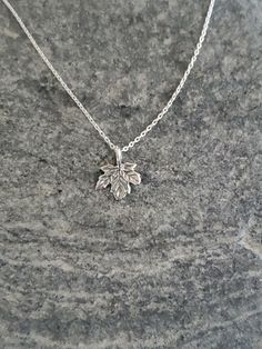 "Tiny sterling silver leaf. This tiny pendant measures 9mm across and is made of solid sterling silver. It hangs from a delicate sterling chain and has a shiny finish with a slightly antiqued look to give the grains in the leaf more texture. Sweet and delicate everyday necklace! Shown here in 16\" length. *If you are unsure of the length you need, or would like to wear this item at different lengths, we now offer an adjustable length option! You can add an adjustable end to your necklace using t Sterling Silver Leaf-shaped Jewelry Gift, Dainty Hallmarked Sterling Silver Charm Necklaces, Dainty Hallmarked Sterling Silver Charm Necklace, Small Hypoallergenic Sterling Silver Charm Necklaces, Small Hypoallergenic Sterling Silver Charm Necklace, Everyday Sterling Silver Leaf Jewelry, Silver Leaf-shaped Sterling Silver Necklace, Tiny Sterling Silver Necklace In Silver, Dainty Sterling Silver Leaf Jewelry