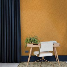 a desk with a plant on it in front of a yellow wall and blue curtains