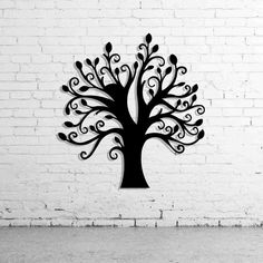 a black metal tree on a white brick wall