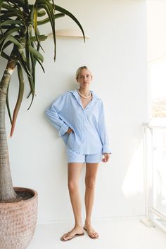 The Océan Blue Cotton Striped Shorts Set features a button-up top and high-waisted shorts crafted from soft, breathable cotton fabric with a subtle pin stripe pattern. Blue Cotton Button-up Shorts, Blue Button-up Cotton Shorts, Blue Shorts For Spring Daywear, Cotton Button-up Shorts For Day Out, Button-up Cotton Shorts For Day Out, Spring Button-up Shorts For Daywear, Blue High-waisted Shorts For Day, Blue Summer Pajama Shorts For Daywear, Blue Pajama Shorts For Spring Daywear