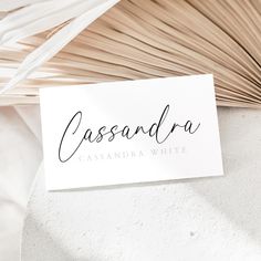 a white business card with the word casssandraa written in cursive ink