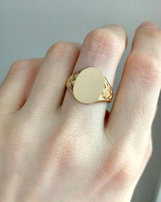 "An elegant 14k yellow gold signet ring with a sleek mid-century aesthetic. The face is oval, flanked by lattice patterned shoulders that add textural interest to the bold size of the cartouche. Measuring approximately 5/8\" north to south by 1/2\" east to west across the face. Currently size 10 and resizable about 2-3 full sizes. Please convo me before purchase if you are interested in the details of our sizing service. Circa 1940, this is one of a collection of old new stock signets we acquire 14k Gold Signet Ring, Mid Century Aesthetic, Initial Monogram, Gold Signet Ring, Monogram Jewelry, Lattice Pattern, Philadelphia Pa, Monogram Initials, Signet Ring