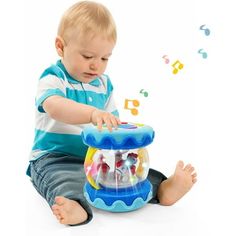 a toddler playing with a toy fish bowl and musical notes coming out of it