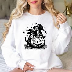 Cat Witches Funny Halloween Sweatshirt, Vintage Cat Witch Sweater, Halloween Sweatshirt, Halloween Pumpkin Sweater, Pumpkin Cat Sweatshirt **PRODUCT DETAILS** - Our sweatshirts are crafted for comfort with a 50/50 cotton-polyester blend. - Designed to last, they feature medium-heavy fabric weighing 8.0 oz/yd². - Enjoy a relaxed fit with a sewn-in label for added durability. - Refer to our true-to-size guide to ensure the perfect fit. **SIZING** - Check our size chart with images to find your bes White T-shirt With Cat Design For Fall, White Cat Print T-shirt For Fall, White Cat Design Top For Fall, Spooky Cat Design Tops For Fall, Halloween Cat Print Crew Neck Sweatshirt, Halloween Cat Print Crew Neck Top, Spooky Fall Tops With Cat Print, Spooky Cat Print Tops For Fall, Casual Halloween Sweatshirt With Cat Design