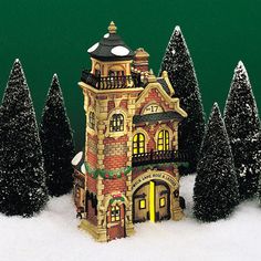 a christmas scene with a building and trees in the snow