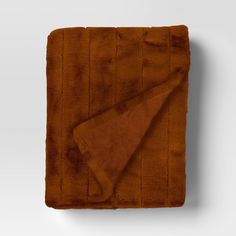 a brown blanket on top of a white wall