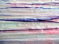 an abstract painting with red, blue and green lines on it's paper texture