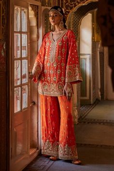 Orange kurta with bead, sequin and zari embroidered floral jaal motifs. Comes with embellished palazzo. - Aza Fashions Traditional Silk Embellished Palazzo Set, Traditional Embellished Kurta For Navratri, Embellished Straight Kurta For Festivals, Embellished Long Sleeve Palazzo Set For Festivals, Long Sleeve Embellished Palazzo Set For Festivals, Traditional Embellished Palazzo Set, Traditional Embellished Straight Kurta Set, Embellished Traditional Straight Kurta Set, Traditional Embellished Kurta For Festivals