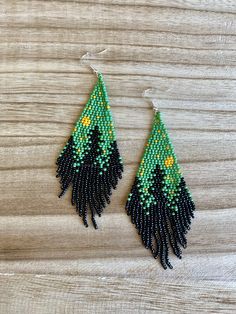 "These gorgeous forest pine tree earrings are handmade and perfect for everyday or a special event. * Silver Plated Hooks (Nickel Free & Hypoallergenic) * Czech Glass Seed Beads * 100% Handmade * Approx. 4\" Long by 1.5\" Wide If you have any questions please ask!" Palm Tree Seed Bead Earrings, Unique Green Teardrop Beaded Earrings, Green Teardrop Earrings With Tiny Beads, Nature-inspired Beaded Dangle Earrings As Gift, Nature-inspired Dangle Beaded Earrings As Gift, Nature-inspired Dangle Beaded Earrings For Gift, Handmade Nature-inspired Dangle Beaded Earrings, Green Dangle Jewelry With Bead Caps, Green Bohemian Earrings With Bead Caps