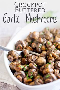 a white bowl filled with cooked garlic mushrooms and garnished with parsley on the side