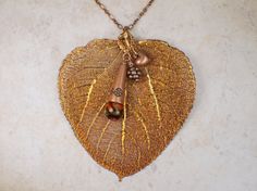 "A real Aspen leaf necklace has been electroplated and dipped in copper to preserve it and its natural beauty. Our beautiful copper leaf has been adorned assorted copper charms and Czech bead charm. The leaf pendant hangs from a 24\" copper plated chain. Aspen leaf is apx. 3\" wide and 3 1/4\" in length. A large statement piece. Every leaf will vary a bit in size and shape since each leaf is is a natural real leaf." Gold Leaf-shaped Copper Jewelry, Copper Leaf-shaped Jewelry Gift, Copper Leaf Jewelry Gift, Bronze Copper Leaf-shaped Jewelry, Nickel-free Rose Gold Copper Necklace, Dragonfly Images, Saint Helens, Aspen Leaf, Real Leaf