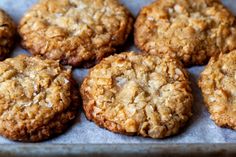 several cookies sitting on top of a baking pan covered in crumbly toppings