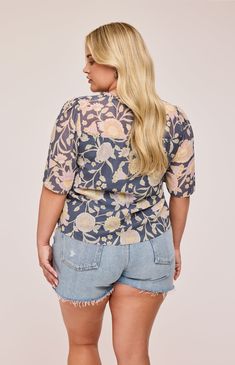 The Alexandra blouse is made of a chiffon fabric with a print designed in-house. Features include delicate ruffle detailing with an embroidered edge, fabric-covered buttons, and a tie detail. Spring Chiffon Top With Blouson Sleeves, Spring Chiffon Blouson Sleeve Top, Flowy Chiffon Blouse With Floral Print, Chic Chiffon Top With Floral Print, Patterned Short Sleeve Blouse With Ruffles, Spring Printed Chiffon Blouse, Feminine Floral Print Patterned Blouse, Feminine Patterned Blouse With Floral Print, Floral Print Chiffon V-neck Top