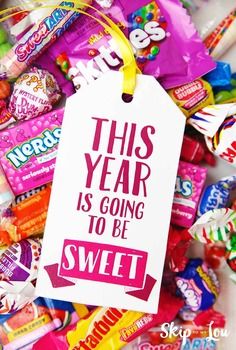 this year is going to be sweet candy gift tag surrounded by colorful candies and lollipops