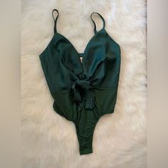 Showpo New Emerald Satin In The Moonlight Deep-V Bow Tank Bodysuit Size 4 Brand: Showpo Size: 4 Color: Emerald Green Features: Adjustable Straps Neckline: Deep V-Neck Sleeve Length: Sleeveless Closure: Side Zip Country/Region Manufacture: Australia Mpn: S003062 Model: Showpo In The Moonlight Bodysuit Condition: New With Tags Check Photos For Measurements And Condition. If You Have Any Questions Or Concerns Please Feel Free To Message Me! All Measurements Are Done With The Garment Laying Flat. Green V-neck Bodysuit For Summer, Green V-neck Bodysuit For Beachwear, Summer V-neck Bodysuit For Night Out, Green V-neck Summer Bodysuit, Elegant Green Bodysuit For The Beach, Solid V-neck Swimwear For Party, Solid Color V-neck Swimwear For Party, Solid Color V-neck Party Swimwear, Green One-piece Bodysuit For Party