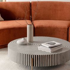 a round coffee table with a vase on top