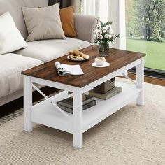 a living room with a couch, coffee table and window