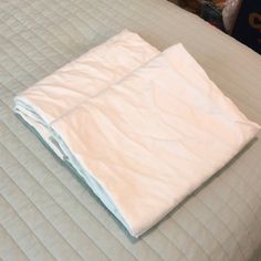 an unmade bed with white sheets on it