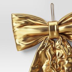 a gold bow is hanging on the wall