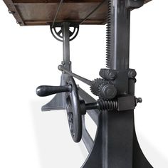 an old fashioned machine with gears attached to it's back end, on a white background