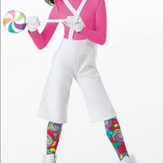 a woman in pink shirt and white pants holding a lollipop