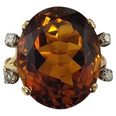 18K Yellow Gold Citrine and Diamond Ring Size 5.25 JAGi Certified- This stunning ring features one oval citrine quartz stone (16 mm x 13.5 mm) and four round single cut diamonds set in 18K yellow gold. Shank: 2 mm. Citrine weight: 11.82 ct. Total diamond weight: .13 ct. Diamond color: H-I Diamond clarity: SI1-SI2 Ring Size: 5.25 Stamped: 18K Weight: 4.0 dwt./ 6.3 gr. JAGi Certificate included. Very good condition, professionally polished. Will come packaged in a gift box or pouch (when possible) and will be shipped U.S. Priority Mail Insured. DV04082417KCS Luxury Yellow Gold Oval Topaz Ring, Luxury Oval Yellow Gold Topaz Ring, Oval Yellow Gold Topaz Ring For Formal Occasions, Luxury Gemstones With Large Stone For Formal Events, Gold Oval Gemstones With Large Stone, Formal Oval Yellow Gold Topaz Ring, Formal Yellow Gold Topaz Gemstones, Luxury Large Stone Gemstones For Formal Occasions, Formal Oval Gemstones With Large Stone