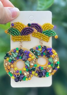 Mardi Gras theme earrings! Beautiful colors with unique designs to choose from 🍦Fun, Lovable gift ideas! ☂️Are you looking for a unique gift or a unique earrings for yourself? 🌈Full of bold color beads! 🌩Message me for Bulk Orders! Perfect gift for friends, families, coworkers, your boss...you name it; they will LOVE it! 🥰(Keep some for yourself!) 🌟These earrings are super light weight! (So light that you forget you have them on!) 🌟Perfect gift for him/her or for yourself! (Get ready to at Mardi Gras Colorful Beads Jewelry Gift, Handmade Adjustable Jewelry For Mardi Gras, Mardi Gras Colorful Beaded Jewelry Gift, Mardi Gras Gift Jewelry With Colorful Beads, Fun Dangling Beads Jewelry For Gifts, Novelty Jewelry With Colorful Beads For Gifts, Handmade Beaded Jewelry For Mardi Gras, Novelty Multicolor Dangle Jewelry, Handmade Round Beads Jewelry For Mardi Gras