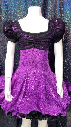 Dazzle and shine in this beautifully crafted purple and black sparkly dress!  Features include, puff sleeves, sequin fabric with incredible shine, a beautiful black lace over the purple, attached black organdy petticoat, finished with fishing line to give it lots of body and sass.  This dress is perfect for a sassy tap number.  The top of the dress is fully lined and has some stretch.  Made here in my shop from high quality materials.   Available in Girls size 10 and 14 (teen XS).  Please see photos for size chart. Chest: Measure across the back and around the fullest part of the chest Waist: Measure around the natural waist Hips: Measure around the widest part of the hips If you have any questions regarding size, fit and color please contact me prior to purchase.  I gladly accept returns Fitted Princess Style Glitter Dresses, Fitted Glitter Princess Dresses, Fitted Princess Style Dresses With Glitter, Fitted Glitter Dress For Pageant, Fitted Glitter Dress For Pageants, Fitted Black Sequin Dress For Costume Party, Black Fitted Sequin Dress For Costume Party, Fitted Purple Dress With Contrast Sequin, Purple Fitted Princess Dress