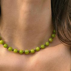 Features Lime Jade and brass beads. This funky necklace in a beautiful bright green shade adds a fun pop of color to any outfit. Jade is considered a protective stone and represents purity, serenity, and nurturing. It is also said to promote the health and wellness of the wearer. Carefully strung along 16" of beading wire and finished off with a gold-tone lobster closure. To maintain the quality of your jewelry and eliminate the risk of tarnishing and other wear, jewelry should be removed prior to entering any type of water. Avoid the use of harsh chemicals, perfumes, or oils around jewelry as well, to reduce the risk of wear. Trendy Green Jewelry With Faceted Beads, Trendy Green Beaded Chain Necklace, Trendy Green Beaded Necklace For Gift, Trendy Green Beaded Necklace, Adjustable Green Beaded Necklace, Trendy Handmade Green Necklaces, Green Jade Beaded Necklace With Large Beads, Green Jade Beaded Chain Necklace, Green Gemstone Beads Necklace