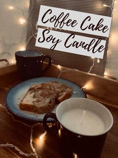 coffee cake soy candle on a plate next to a cup of coffee and a sign that says coffee cake soy candle